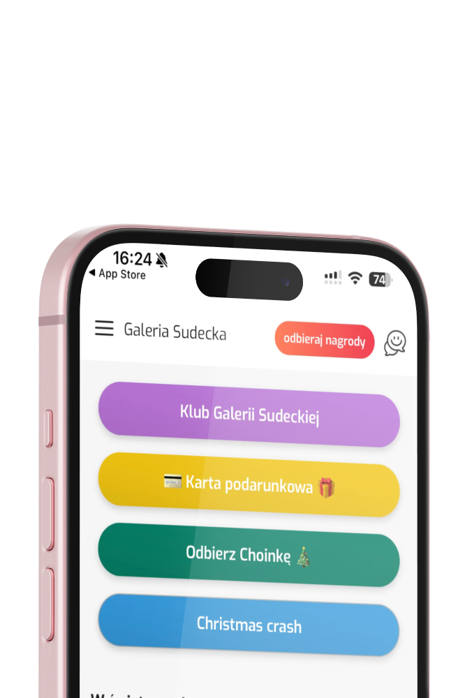 Wizualizacja telefonu typu iphone z ekranem otwartej aplikacji mobilnej Galerii Sudeckiej, w której widać opcję zalogowania i cztery guziki - karta podarunkowa, klub galerii sudeckiej, odbierz choinkę i christmass crash.